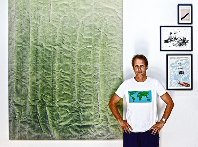Mr. Kagge stands in front of Tauba Auerbach's 'Untitled' and three works by Ray Pettibon.
